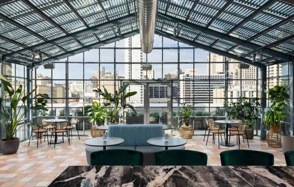 A restaurant with a glass roof and a view of the city offering the best breakfast in San Francisco.