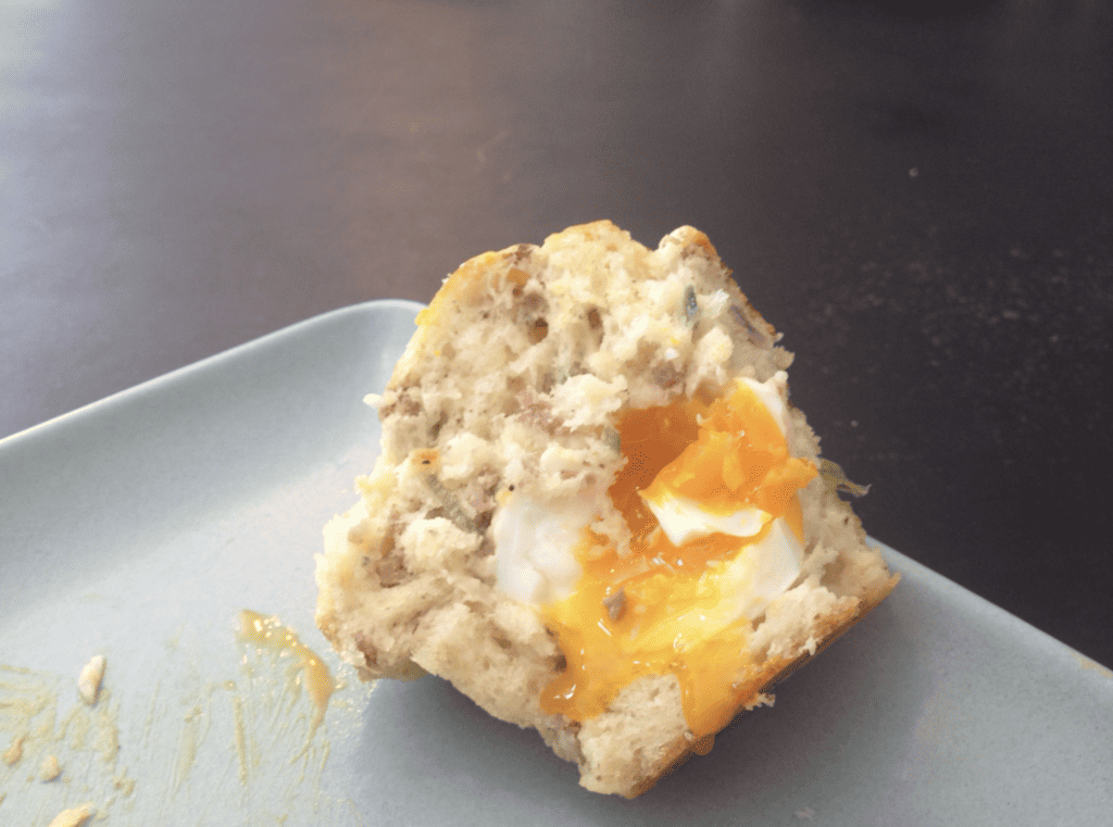The best breakfast in San Francisco awaits you with a delicious muffin topped with a perfectly cooked egg, served on a plate.