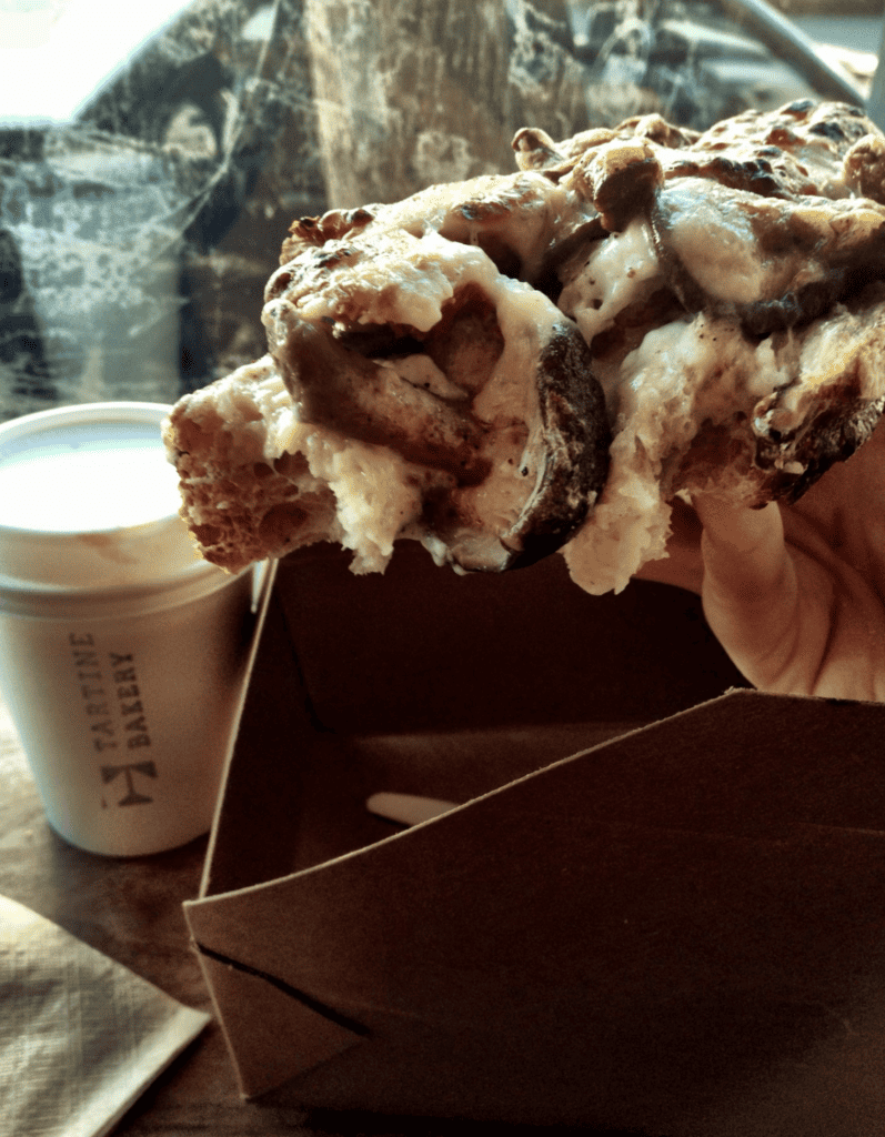 A person is holding a pastry, undoubtedly the best in San Francisco.