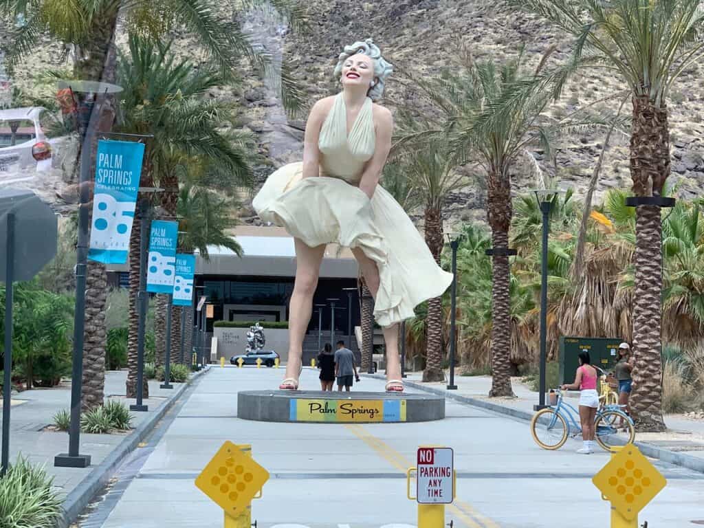 An iconic statue of Marilyn Monroe graces the vibrant sidewalks of Palm Springs, making for an engaging Instagram caption-worthy spot.
