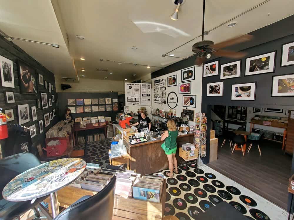 A Palm Springs coffee store with a lot of pictures on its walls.