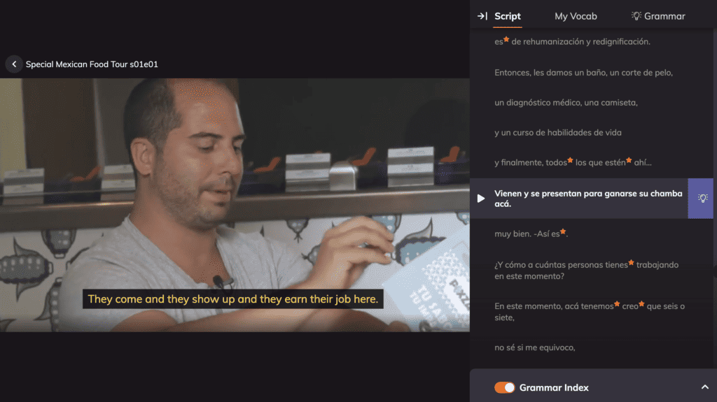 A man concentrating on language learning using a computer application with subtitles displayed, akin to the Lingopie review experience for Netflix-style content.